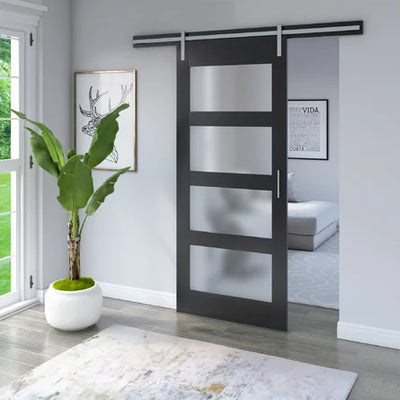 Modern interior featuring a sleek sliding door with frosted glass panels, alongside a potted plant and large windows for natural light.